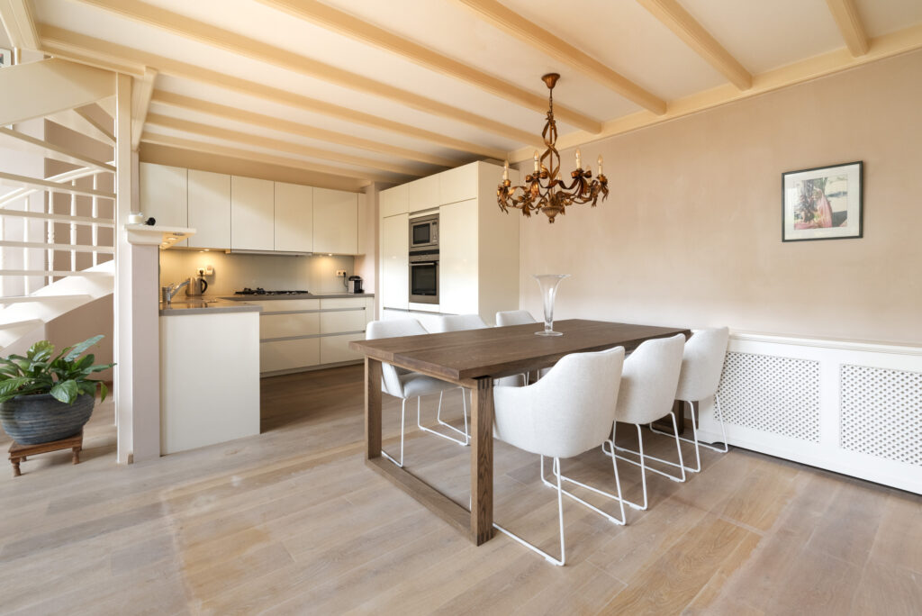 Modern kitchen and dining room with chandelier.