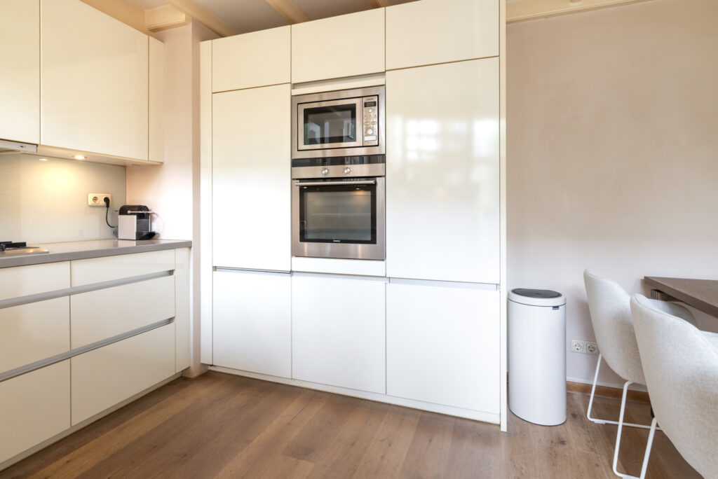 Modern kitchen with built-in appliances and minimal design.