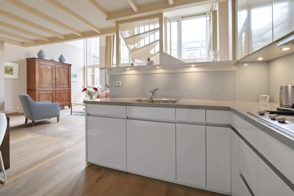 Modern kitchen and living room with wooden floors