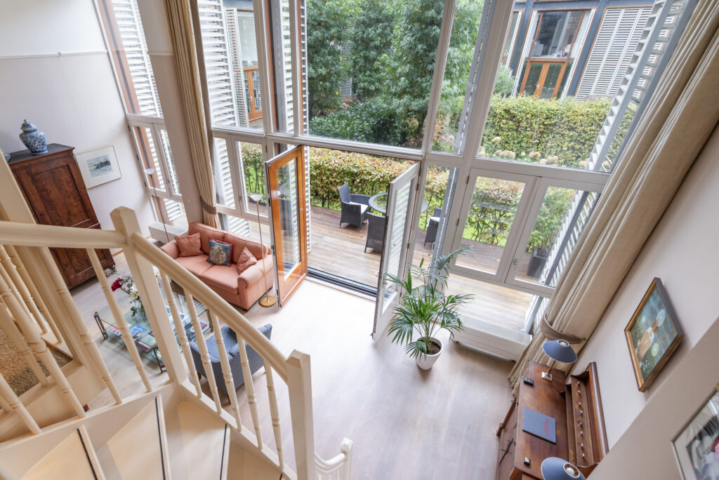Cozy living room with large windows and balcony.