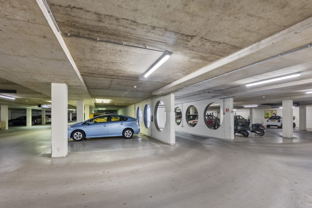 Underground parking garage with cars and motorcycles