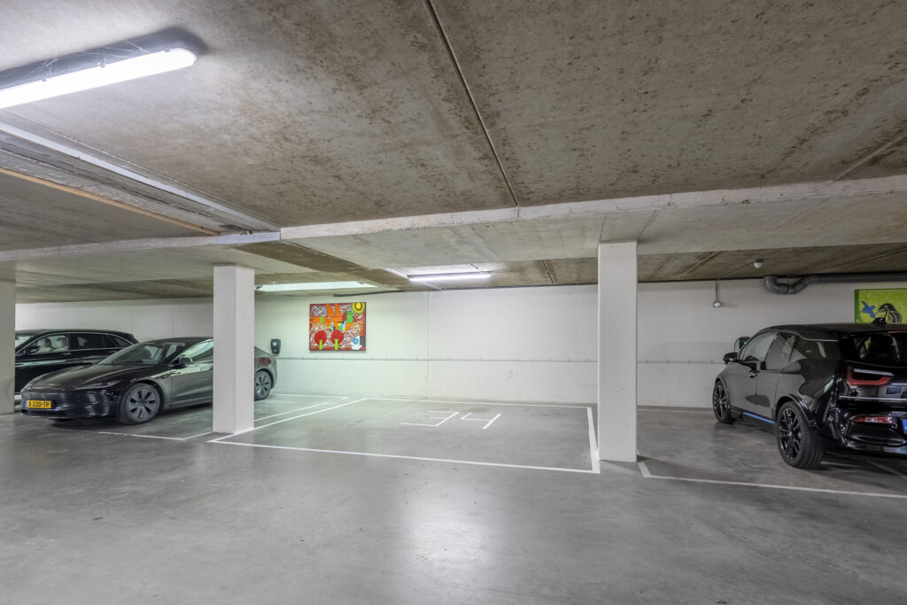 Underground parking garage with electric vehicle charging stations.
