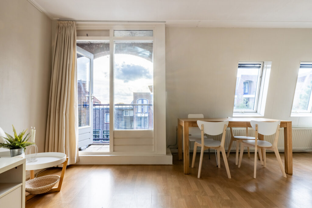 Bright room with table and balcony view.