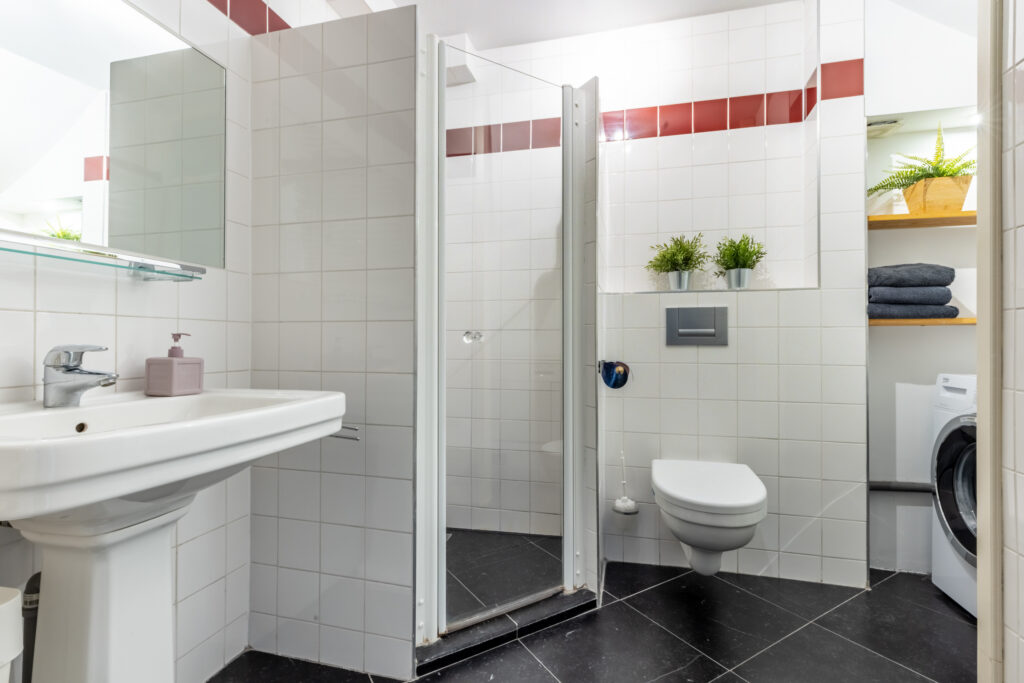 Modern bathroom with shower and washing machine