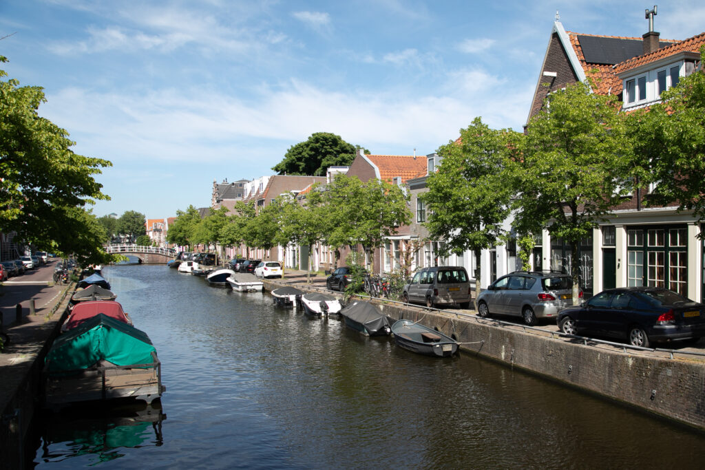 Canal scene with boats and waterfront houses.