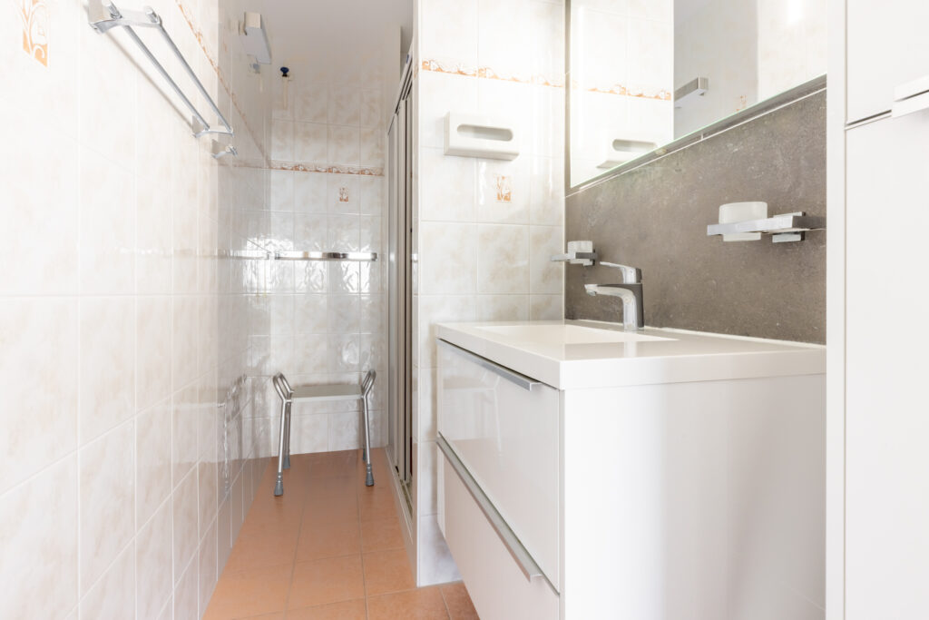 Modern bathroom with sink and shower seat