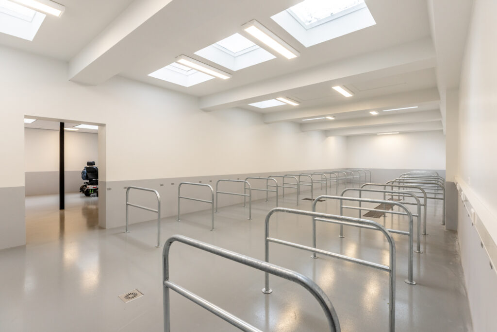 Spacious indoor facility with metal barriers and wheelchair.