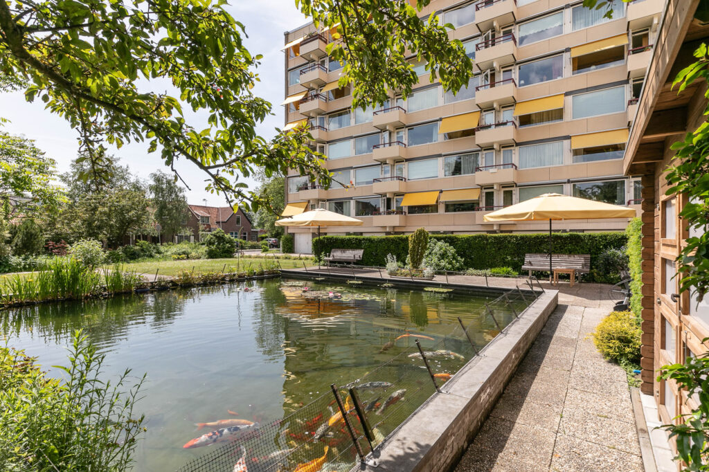 Apartment building with koi pond and garden.