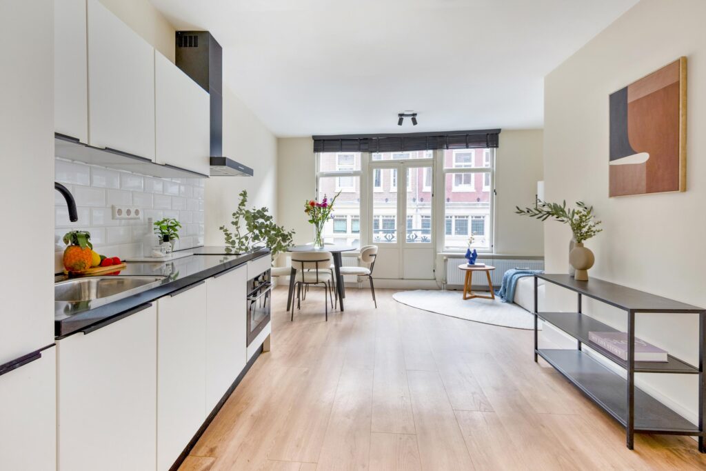 Modern kitchen and dining area with plants and art