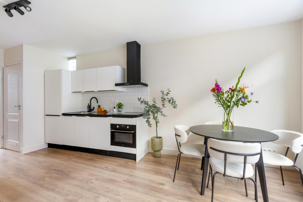 Modern kitchen with plants and round table