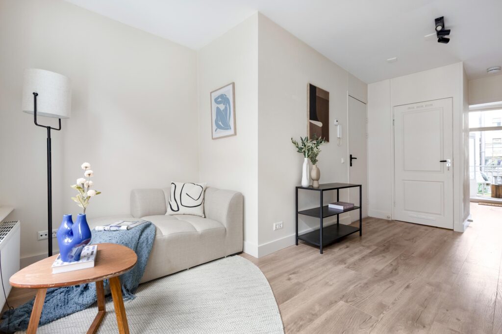Modern living room with light decor and artwork.