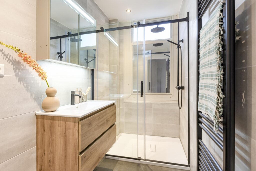Modern bathroom with glass shower and wooden vanity