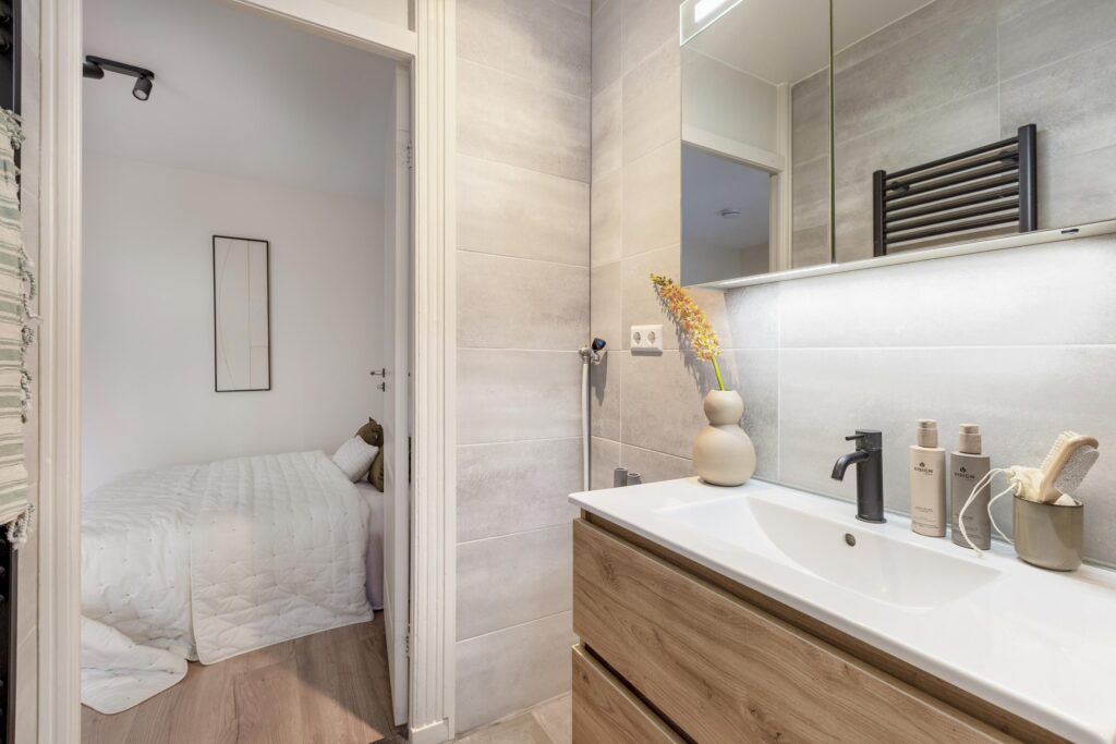 Modern bathroom with adjoining bedroom view