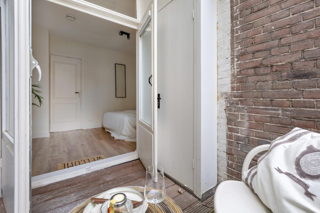 Cozy bedroom view from a terrace entrance.