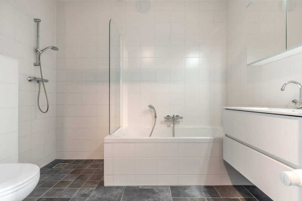 Modern white bathroom with shower and bathtub.