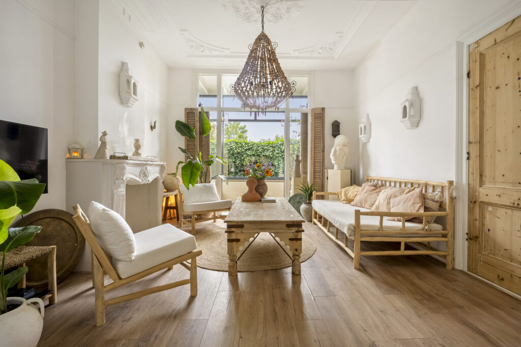 Bright living room with wooden furniture and plants.