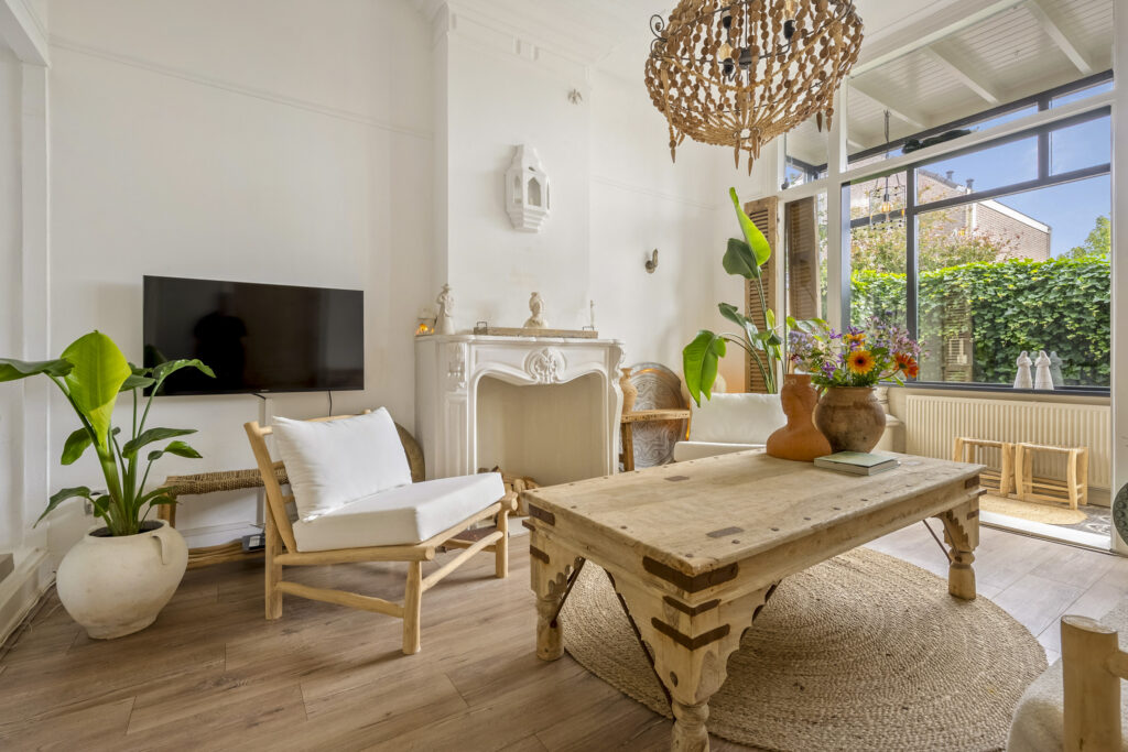 Cozy living room with plants and natural decor.