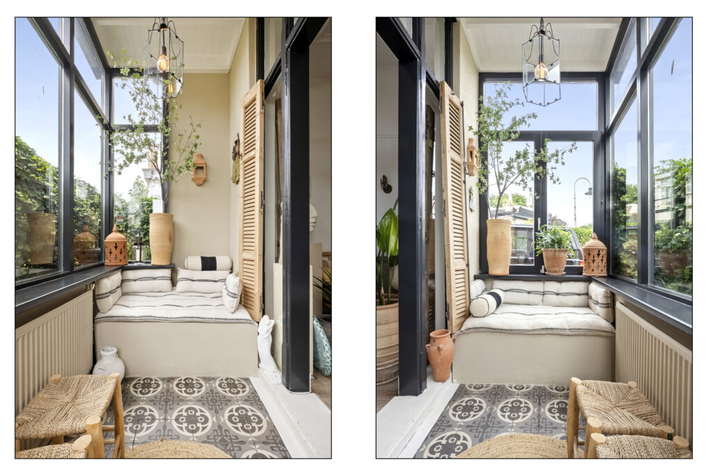 Cozy sunroom with cushions and potted plants.