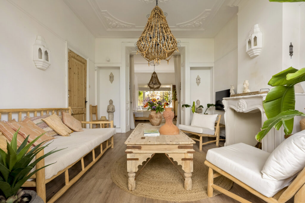 Rustic living room with wooden furniture and plants.