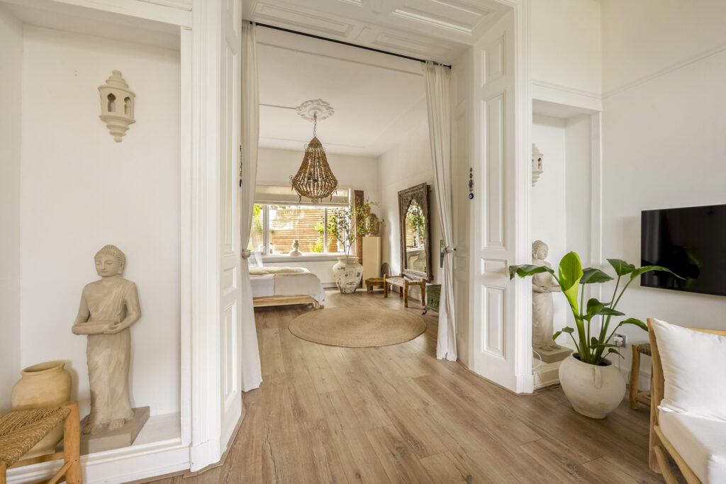 Serene living room with plants and statues