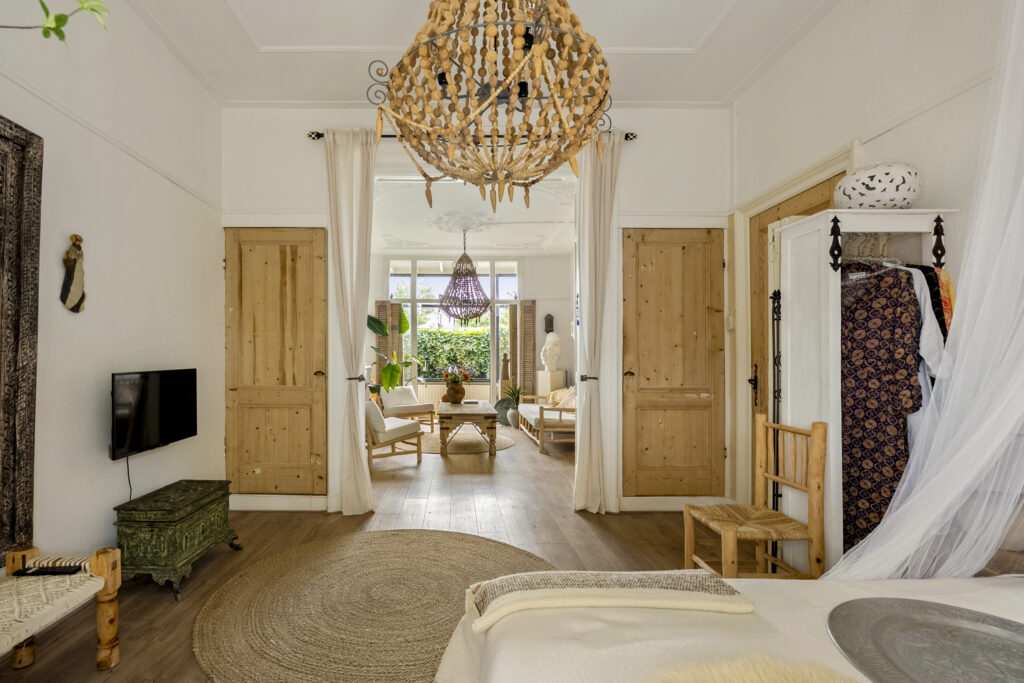 Cozy living room with wooden decor and chandelier.