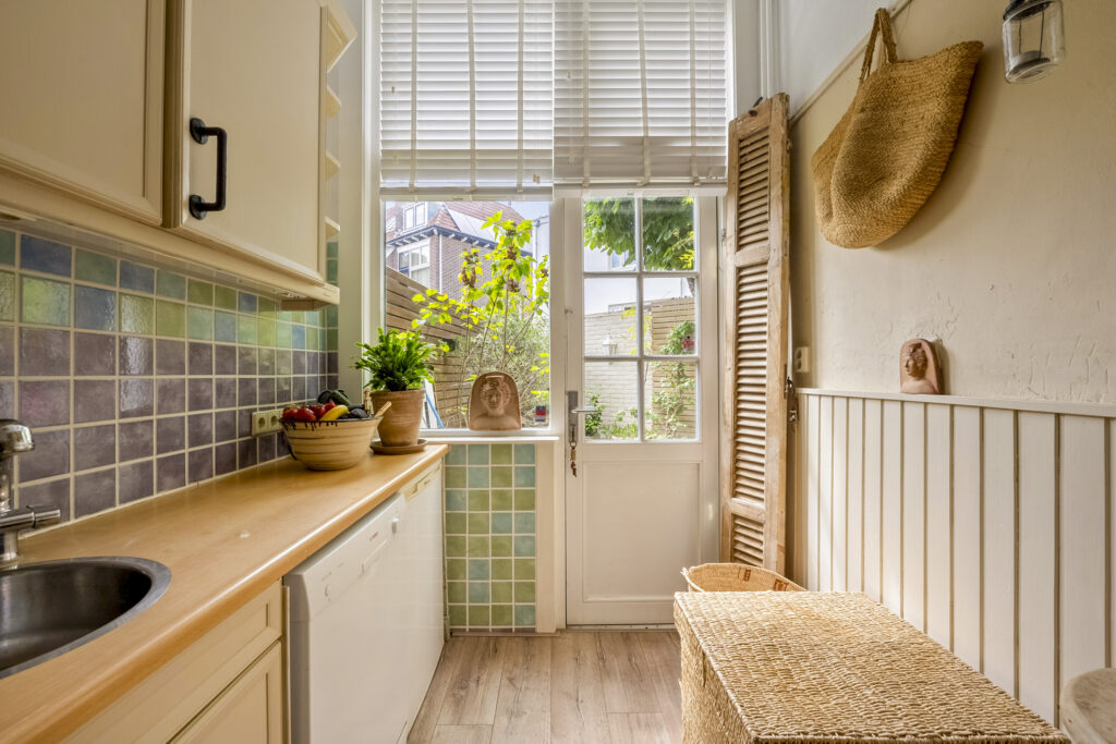 Cozy kitchen with colorful tiles and natural light.