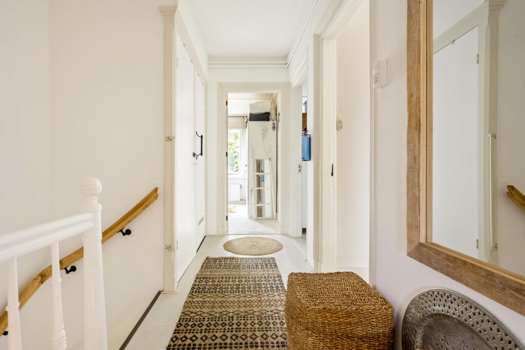 Bright hallway with woven rug and basket