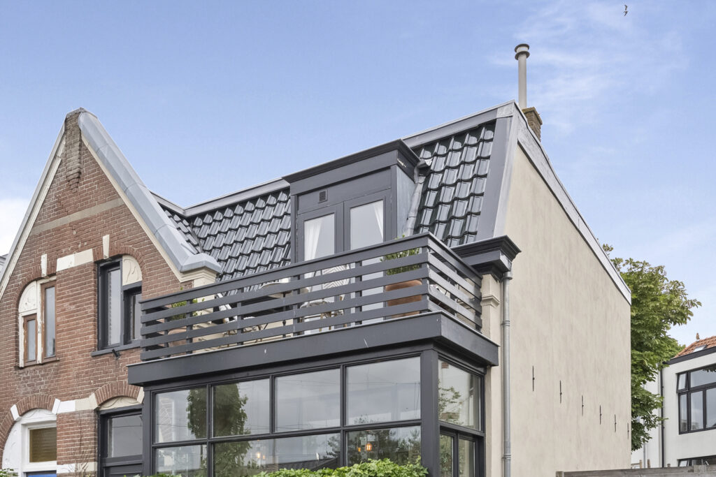 Modern two-story brick house with balcony.