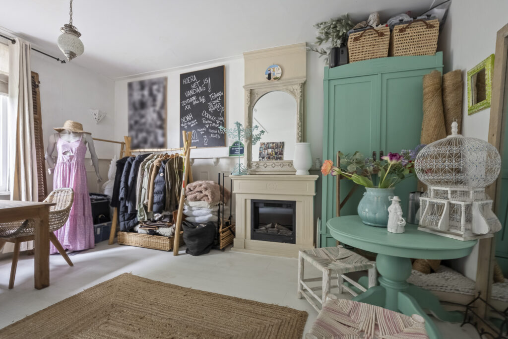 Cozy room with wardrobe, fireplace, and mannequin.