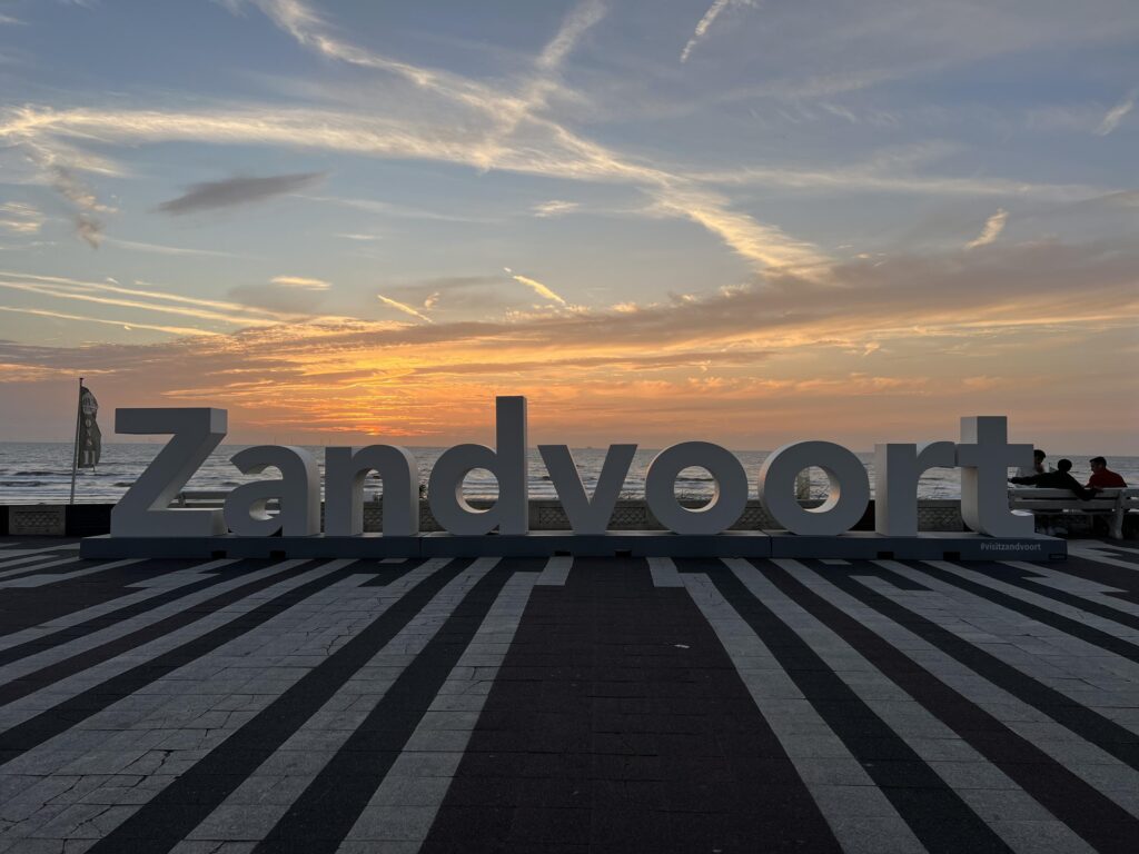 Zandvoort sunset with large sign on beach.