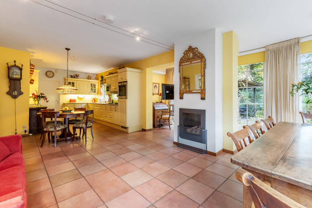 Cozy open kitchen and dining room with fireplace.