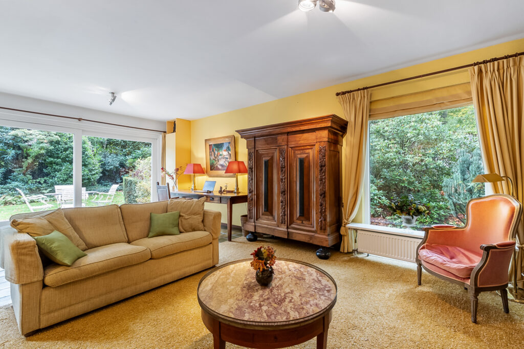 Cozy living room with garden view and antique furniture.