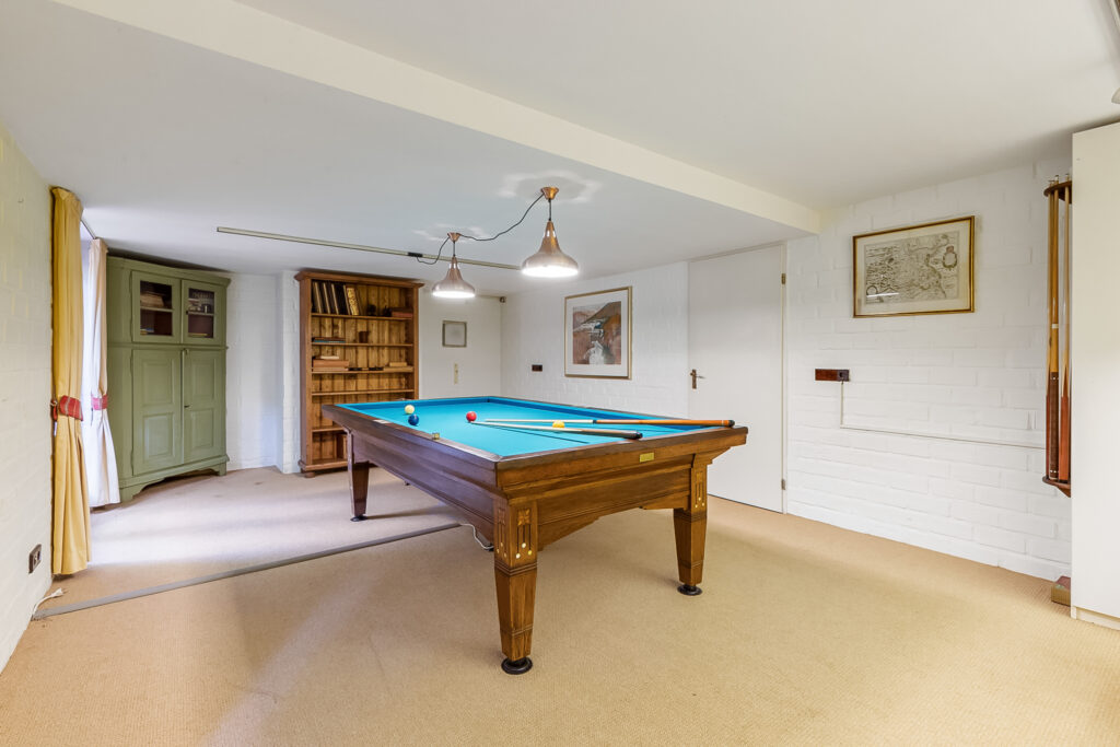 Cozy room with billiard table and bookshelf