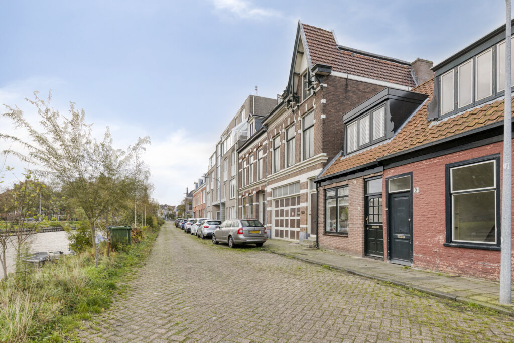Charming street with historic buildings and parked cars.