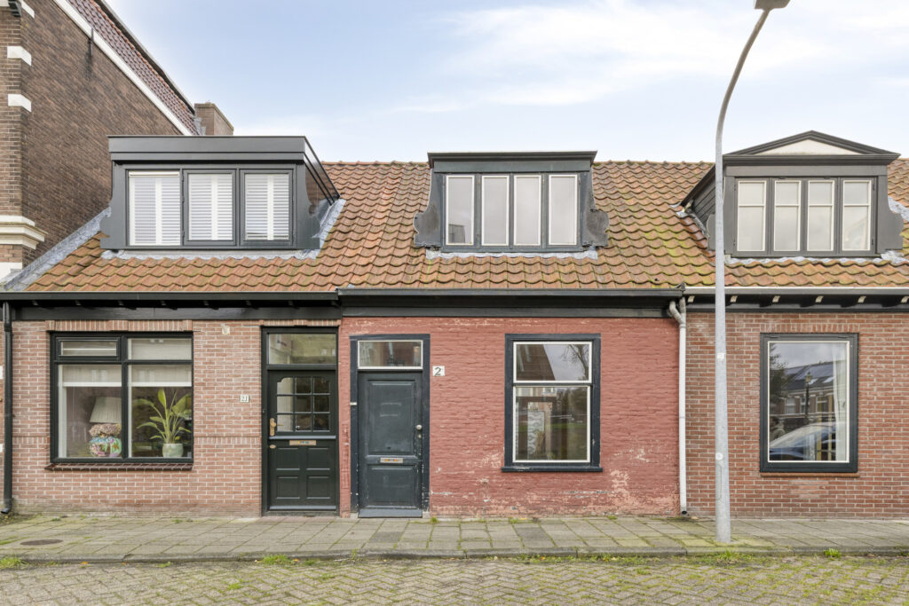 Charming brick house with dormer windows.