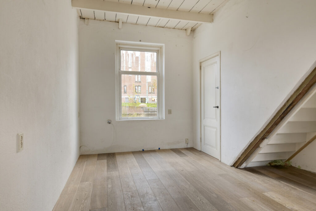 Empty room with wooden floor and window