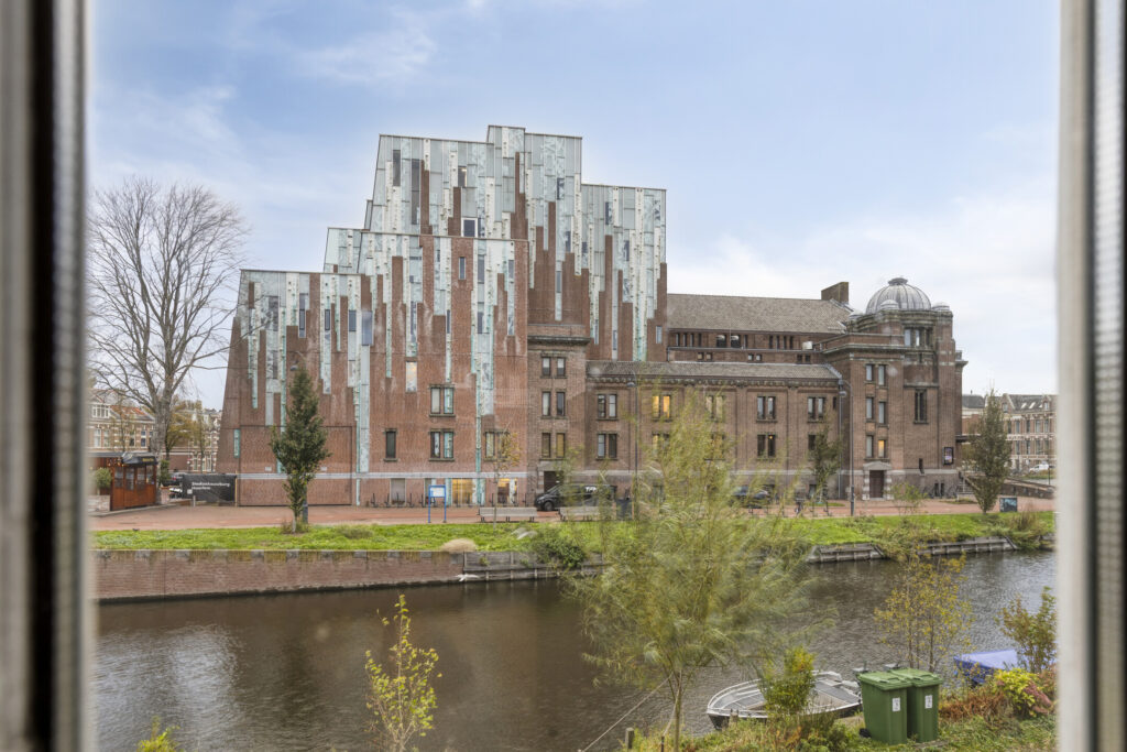 Modern brick building by canal.