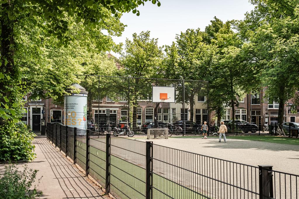 Children playing basketball in urban park