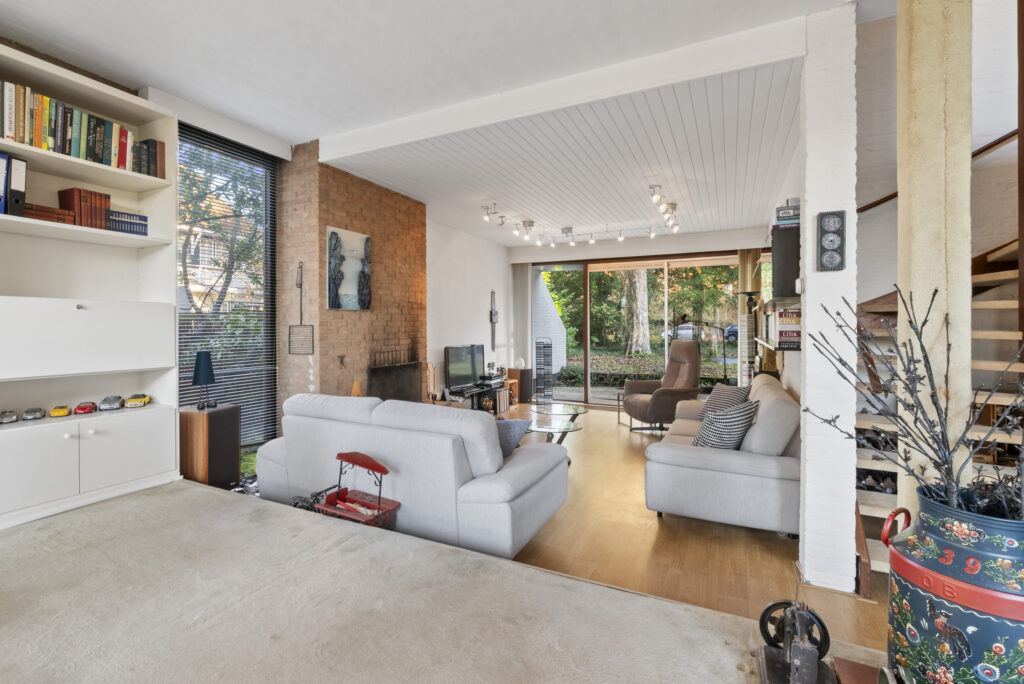 Cozy living room with modern furniture and large window.