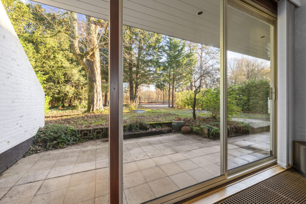 Patio view through sliding glass door to garden.