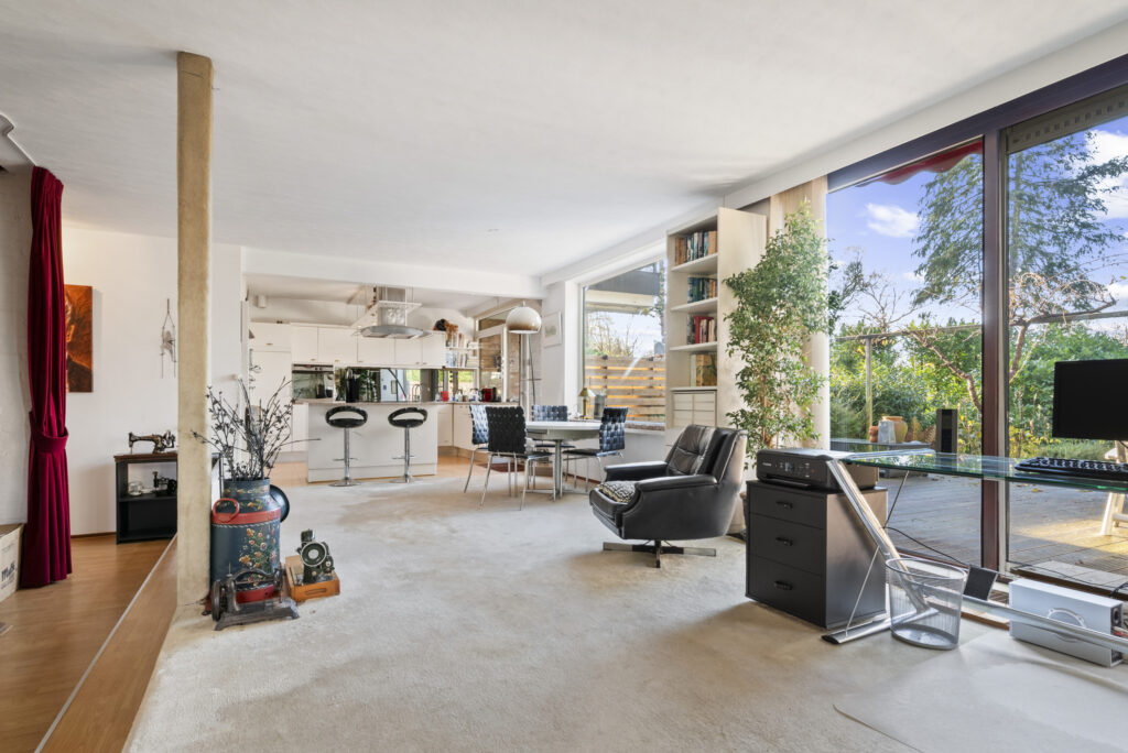 Modern open-plan living room with garden view.