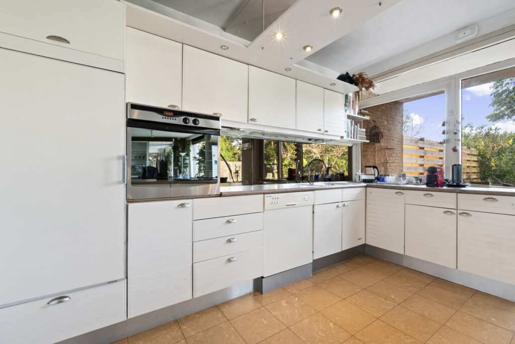 Modern kitchen with white cabinets and appliances