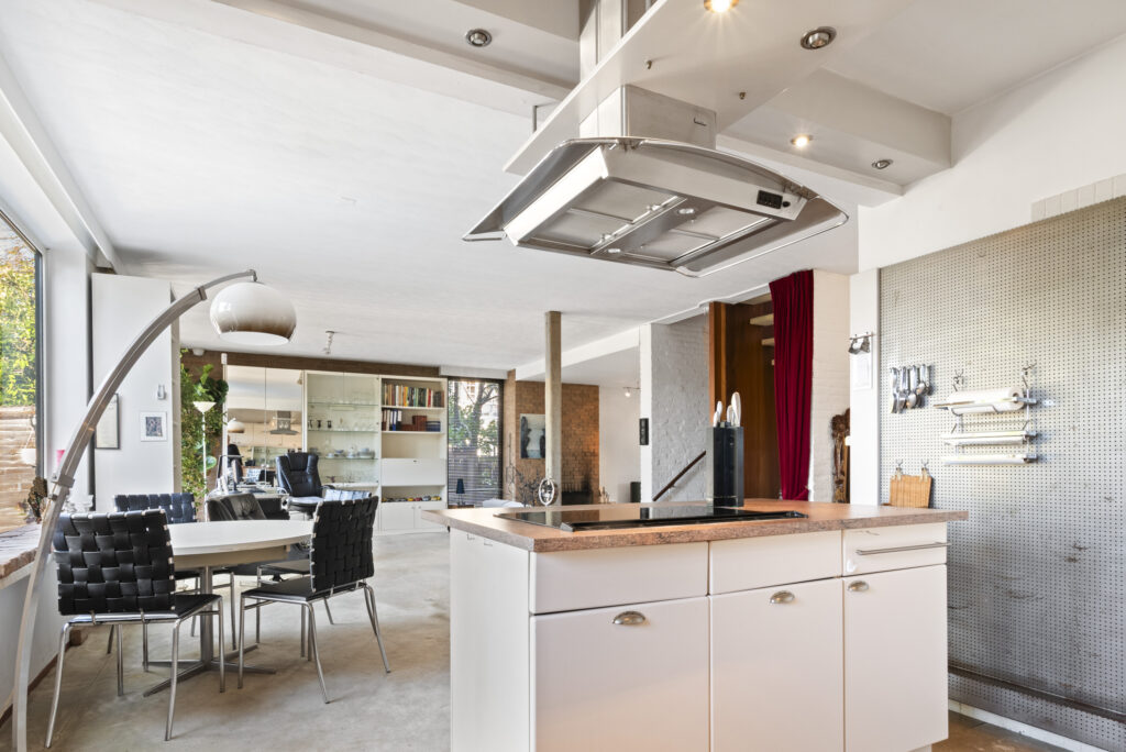 Modern open-concept kitchen and dining area with island.