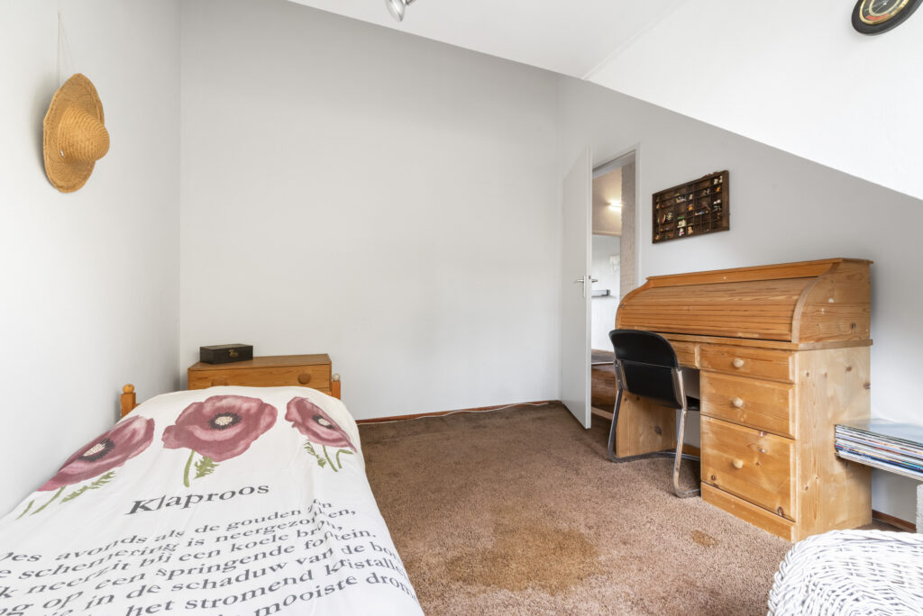 Cozy bedroom with wooden desk and bed