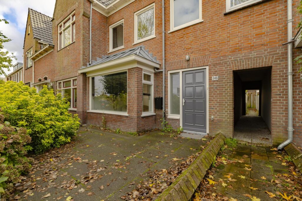 Brick townhouse with gray door and windows.