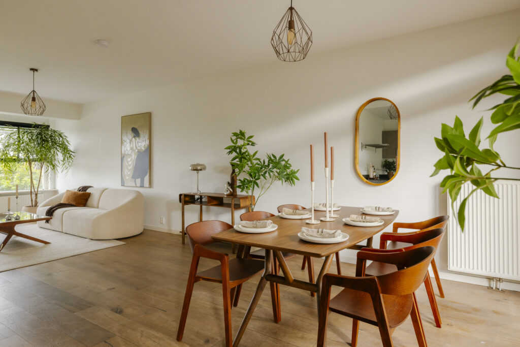 Modern dining and living room with plants and decor.