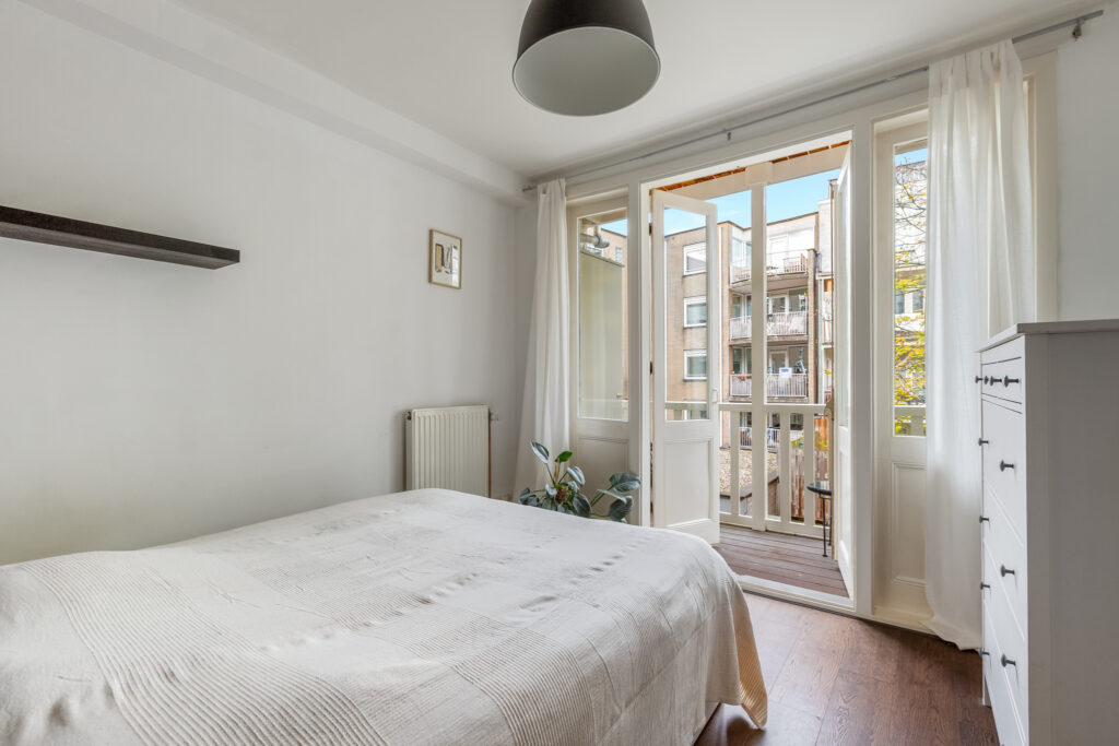 Bright bedroom with balcony view