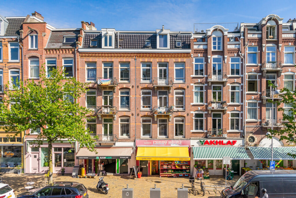 Brick apartment buildings with shops and trees