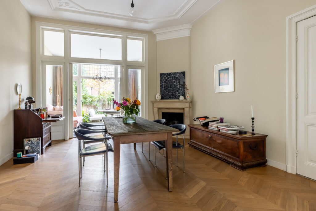 Elegant dining room with fireplace and garden view.