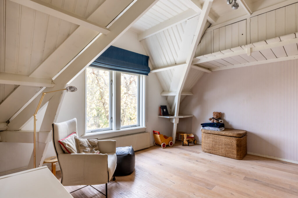 Cozy attic room with toys and wicker basket.